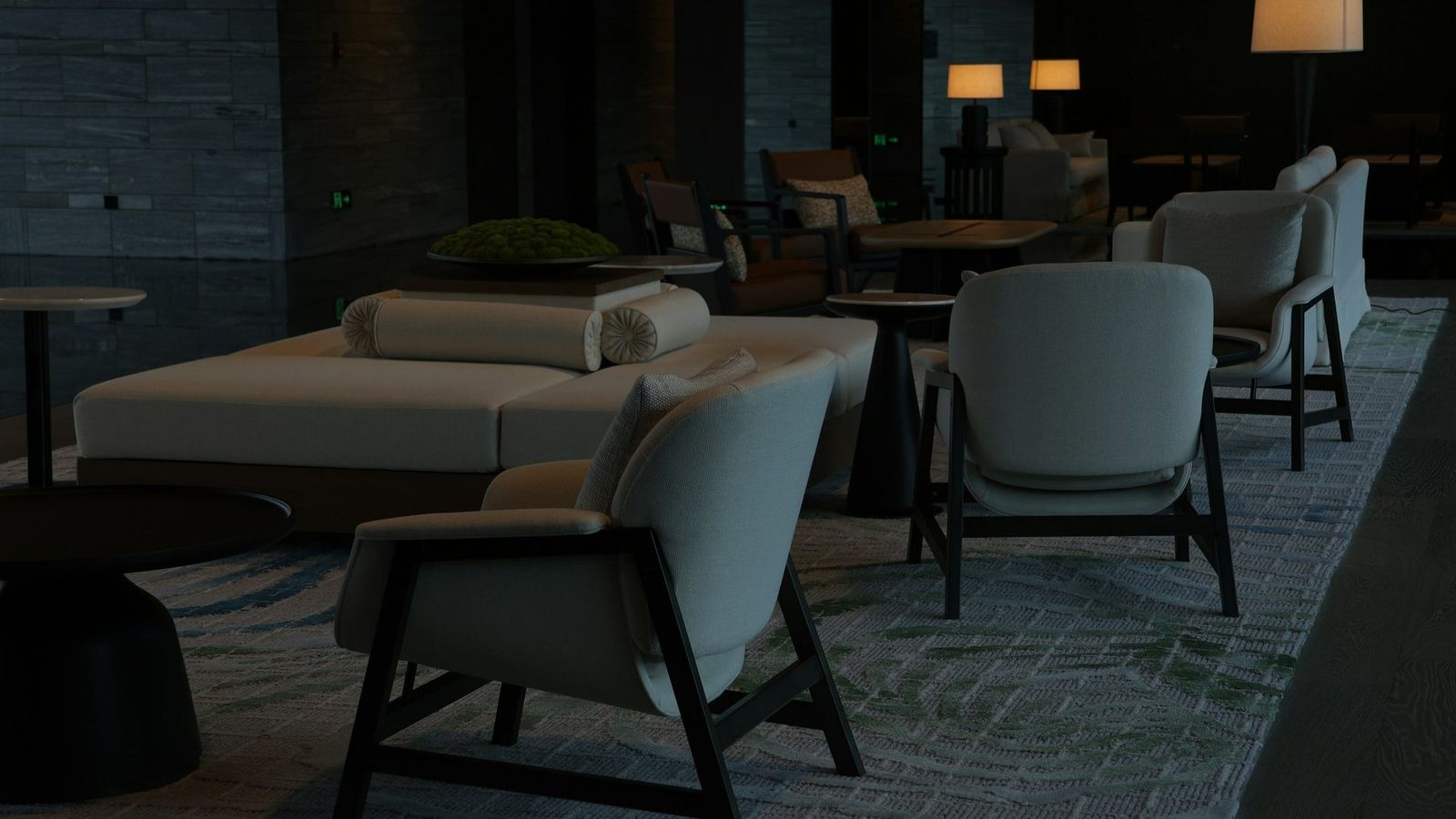 Softly lit upscale hotel lounge with stone walls